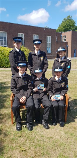 Group image of Police Cadets sat in front of Exeter Middlemoor HQ
