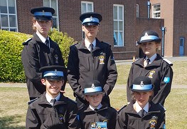 Group image of Police Cadets sat in front of Exeter Middlemoor HQ