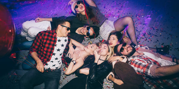 Young people laying on the floor having fun, althoughone has worried eyes