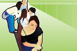 A young person sitting on one ending of a bench feeling down while at the other end a gang of young people talking and laughing