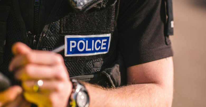 Police officer writing in his note pad