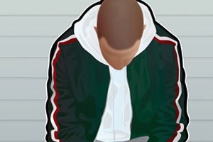 A young lad sat in a prison cell looking at his feet